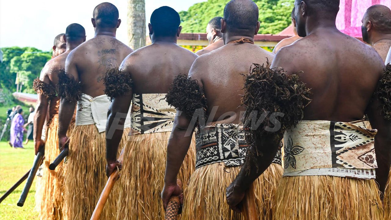 Fijian villagers gathered in a traditional ceremony, highlighting their connection to the land