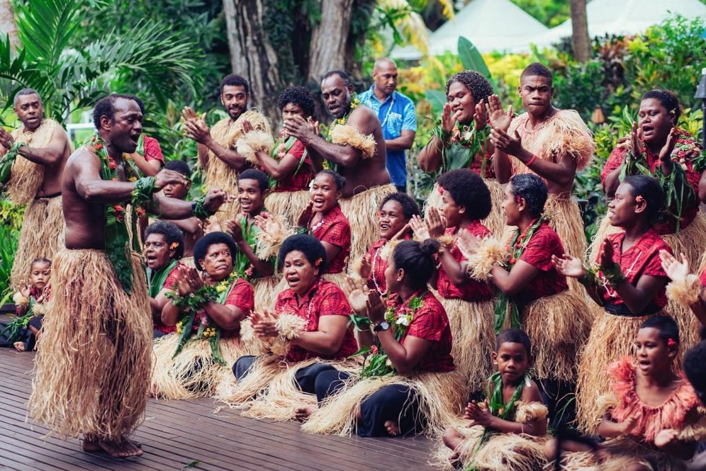 Fijian villagers gathered in a traditional ceremony, highlighting their connection to the land